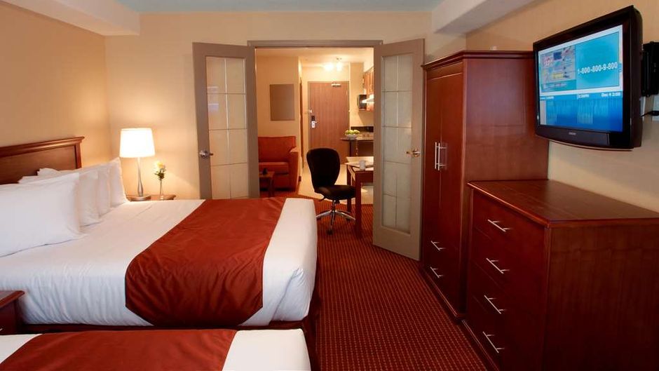 Merit Hotel & Suites Room
