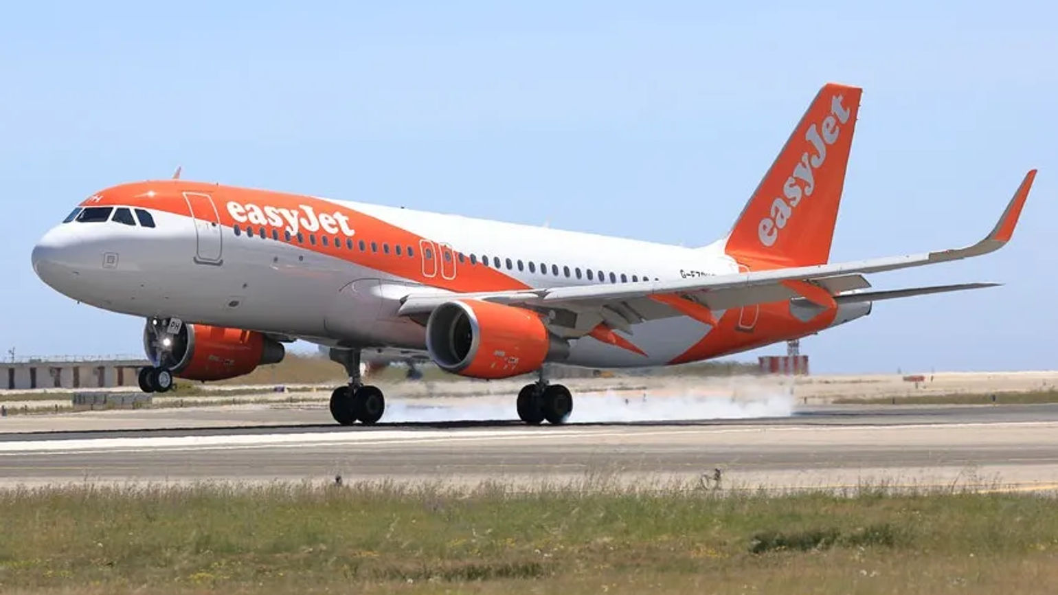 EasyJet A320  taxis along a runway.