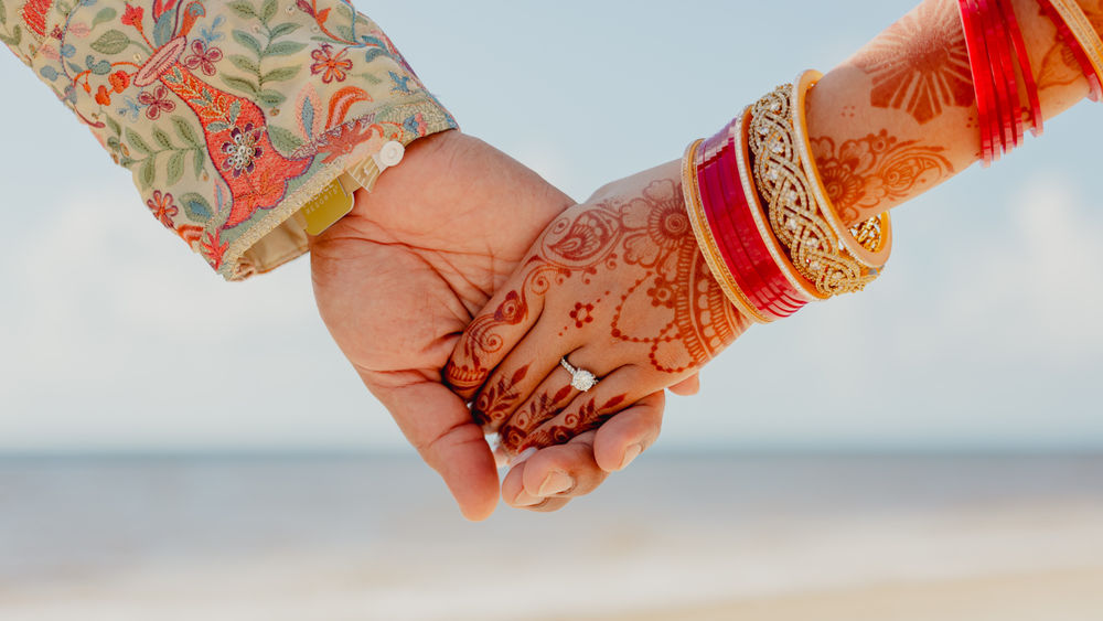 During the mehndi portion of a South Asian wedding, the bride’s hands and feet are covered in symbolic henna designs.