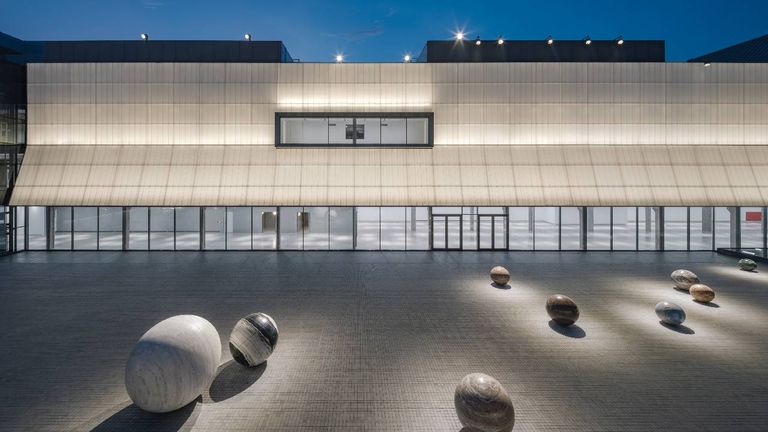 Polished marbles by artist Alicja Kwade adorn a courtyard at Dib Bangkok.