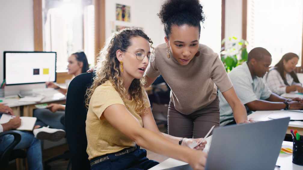Talking, planning and business people in training with a laptop for leadership and mentoring. Meeting, project management and women speaking about online strategy, ideas or inspiration at work.