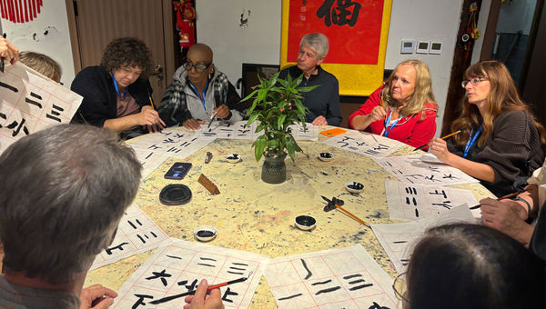Travel advisors try their hand at Chinese calligraphy.