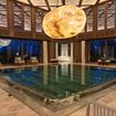 A moonlike sculpture is suspended above a pool at the Medi-Spa Royal Mansour Tamuda Bay.