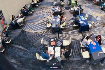 Attendees meet at small tables in a chandelier-lit ballroom during Northstar Meetings Group’s Destination Midwest 2026 event in Grand Rapids.