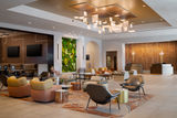 Renovated lobby at Hilton Santa Clara with lounge seating, a living green wall and a tech-inspired light fixture.