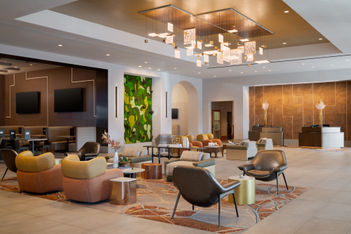 Renovated lobby at Hilton Santa Clara with lounge seating, a living green wall and a tech-inspired light fixture.