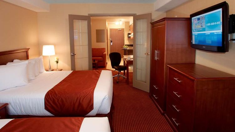 Merit Hotel & Suites Room