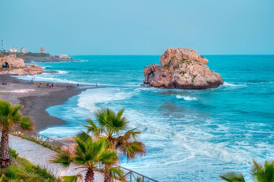 beach in spain with big rock