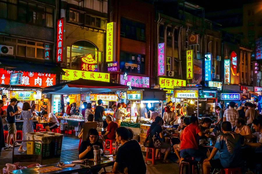 Many people eating & drinking in Ningxia Road Night Market, a famous snack street in Taipei City