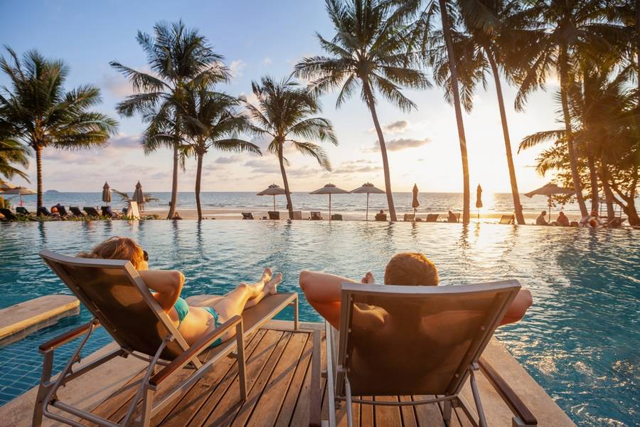 couple on the beach near swimming pool, luxury travel