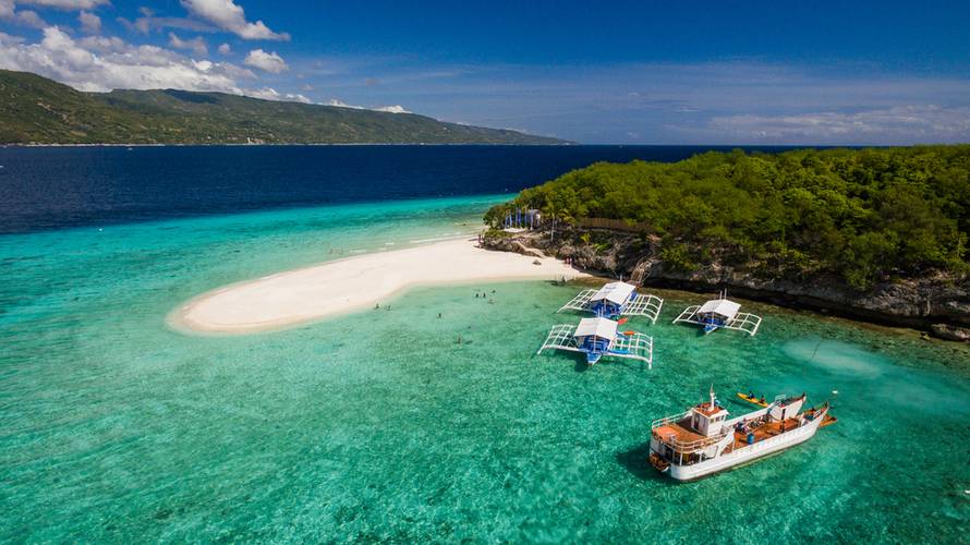An aerial perspective of the Sumilon island beach landing near Oslob, Cebu, Philippines.