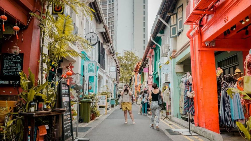 Traveller taking a photograph in Haji Lane in Kampong Glam, Singapore.