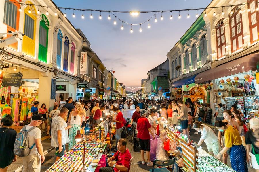Tourists are walking on the Phuket Walking Street is a night market that takes over the beautiful Thalang Road in Phuket Old Town every Sunday evening