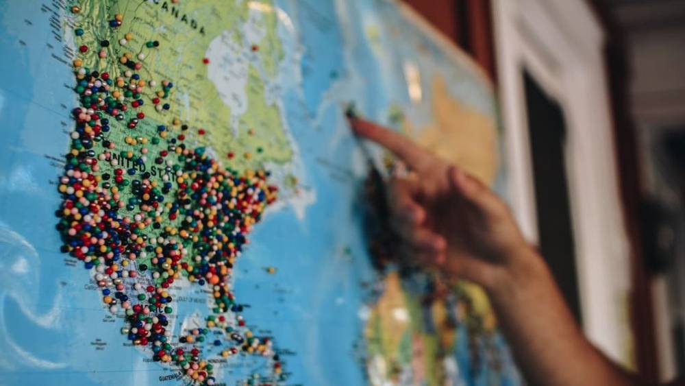 World map with pins in it for planning travel
