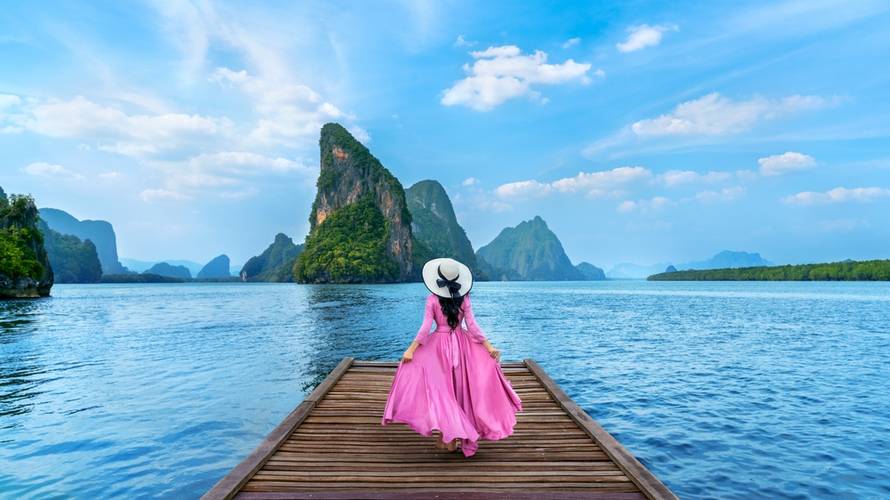 Tourist walking on wooden bridge in Phang nga bay, Thailand.