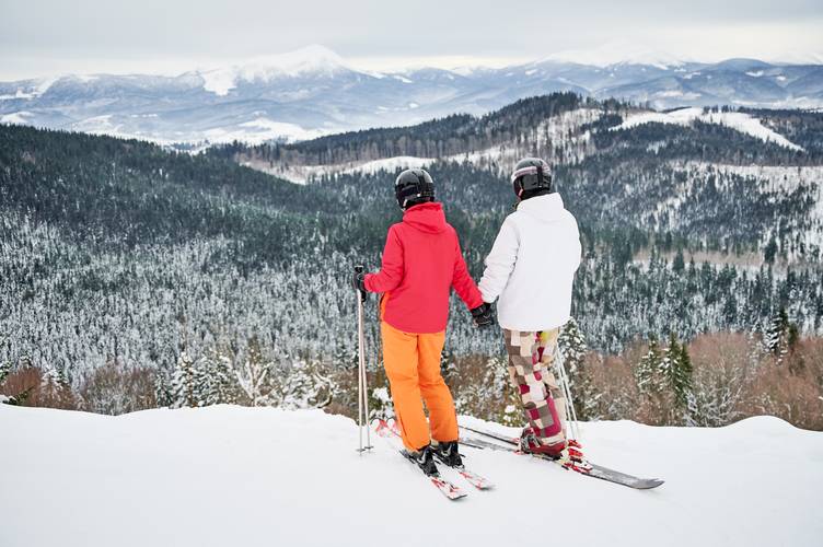 Friends skiers having fun at ski resort in the mountains in winter skiing