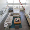 High ceilings looking down from loft mezzanine to downstairs living area.