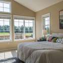 Main floor primary bedroom overlooking the pond