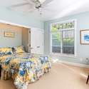 Bedroom with custom retractable wall bed can be used as office or den.