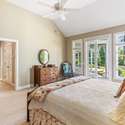 Primary suite with door to outdoor living space.