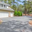 2-car garage with golf cart garage, walk-in storage and utility sink.