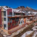 New construction featuring stone and metal exterior. Reinforced steel for the future balconies in place