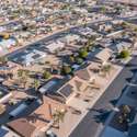 A panoramic view capturing the charm of Sun City West with its palm-lined streets, beautifully maintained homes, and a vibrant community ideal for active adults.