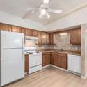 This well-lit kitchen features classic wood cabinetry, tiled backsplash, and abundant storage. With a functional layout and updated flooring, this space is perfect for meal prep and casual dining. Located in a prime Phoenix location near shopping, dining, and entertainment.