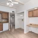 This versatile kitchen layout includes a dedicated workspace, perfect for meal planning or a home office setup. Featuring wood cabinetry, a tiled backsplash, and built-in shelving, this kitchen combines efficiency and style in a desirable Phoenix neighborhood.