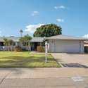 This charming Gemini Twin home in Sun City, AZ, boasts a lush front lawn, well-kept landscaping, and a spacious covered courtyard. A perfect blend of privacy and curb appeal in an active adult community.