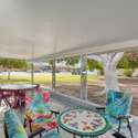 This screened-in back patio is the perfect setting for outdoor meals, reading, or entertaining guests, all while enjoying scenic backyard views.