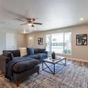 This remodeled living space offers a seamless flow between the family room, dining area, and kitchen. Large windows, recessed lighting, and neutral finishes create a warm and inviting atmosphere.