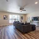 A spacious and inviting living area with updated flooring, fresh paint, and recessed lighting. Perfect for entertaining or enjoying peaceful Sun City living.