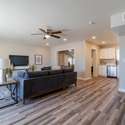 This modern, open-concept living space features neutral tones, updated flooring, and natural light perfect for hosting guests or enjoying quiet moments in a comfortable, move-in-ready home.