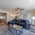 A spacious and inviting living area featuring modern recessed lighting, neutral tones, and stylish laminate flooring. The seamless open floor plan is perfect for relaxation or entertaining guests.