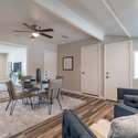 This versatile dining space flows effortlessly into a casual lounge area, offering updated flooring, recessed lighting, and flexible design for modern living.
