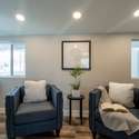 A bright and cozy sitting area with dual-pane windows, stylish accents, and recessed lighting. An ideal space to enjoy natural light and relaxation.