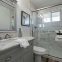 A spa-like bathroom featuring a glass-enclosed shower with marble-style tile, a chic vanity, and updated fixtures. The perfect combination of luxury and functionality.
