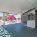 Enjoy year-round outdoor living with this spacious covered patio. Ideal for entertaining or relaxing, this space offers privacy and shade for added comfort.