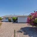 This spacious backyard offers a serene desert landscape with low-maintenance gravel and mature shrubs. The open layout provides plenty of potential for adding a patio, garden, or outdoor entertaining space in a peaceful Arizona setting.