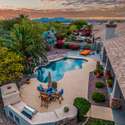 The elevated backyard setting captures sweeping mountain vistas and nightly sunsets. Surrounded by desert flora and built for entertaining, this backyard offers the ultimate Scottsdale lifestyle with poolside dining and expansive views.