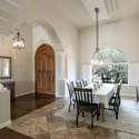 A graceful formal dining room opens from the arched foyer, accented by dramatic pillars, natural light, and classic finishes. Perfect for hosting or holiday gatherings in this sophisticated Scottsdale residence.