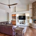 Warm up by the striking stone fireplace in this inviting great room featuring built-in media shelving and a sleek wet bar. Ideal for cozy evenings or entertaining in your North Scottsdale retreat.