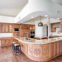 This chef-inspired kitchen offers a grand curved island with seating, granite countertops, and custom cabinetry. Enjoy high-end finishes and ample prep space for hosting or everyday living.