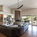 Open the doors to luxury living with this spacious great room. Features include hardwood floors, a stacked-stone fireplace, and access to your private backyard oasis in sunny Scottsdale.