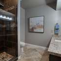 With rich tilework, walk-in glass shower, granite vanity, and soft lighting, this renovated guest bath feels like a private spa in the heart of Scottsdale.