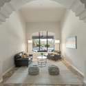 Enjoy the elegance of arched pillars, tile flooring, and picture windows framing the backyard an ideal setting for entertaining or relaxing in refined style.