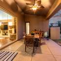 The glow of sunset illuminates this covered space, creating a cozy ambiance perfect for intimate dinners or relaxed evening lounging. The design highlights energy-conscious features and effortless flow.