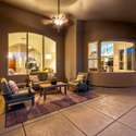 As evening falls, this peaceful outdoor lounge glows with warmth and charm. The ideal backdrop for unwinding after a long day, this covered space balances privacy with inviting ambiance.