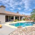 Surrounded by tropical landscaping, this resort-style backyard offers a shimmering pool with waterfall accents and vibrant foliage. A true entertainer s dream nestled in a scenic Arizona setting.